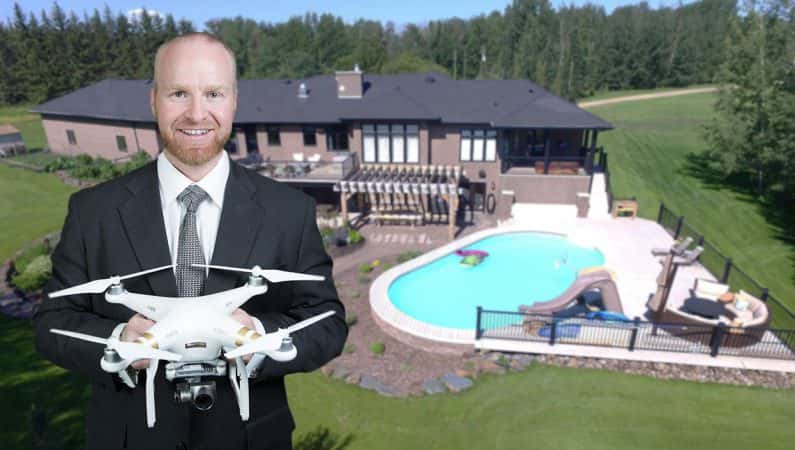 Carson Beier (Holding a Drone in front of a Home)